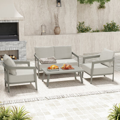 Ensemble de conversation de patio en aluminium 4 pièces avec causeuse, table basse et coussins gris Heitzman