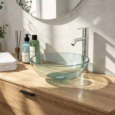 Vasque ronde à poser en verre trempé transparent avec robinet chromé et bonde clic-clac.