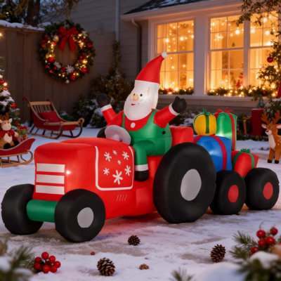 Père Noël gonflable sur remorque avec charge de cadeaux