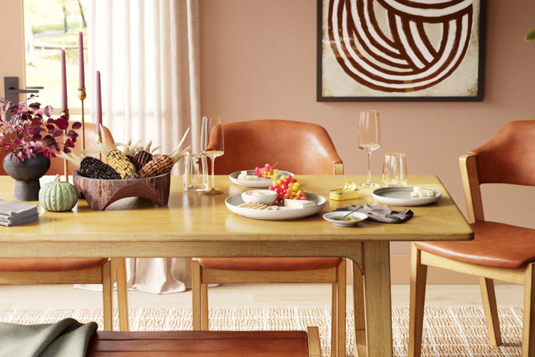 rustic wooden table with fall-themed food and dishes