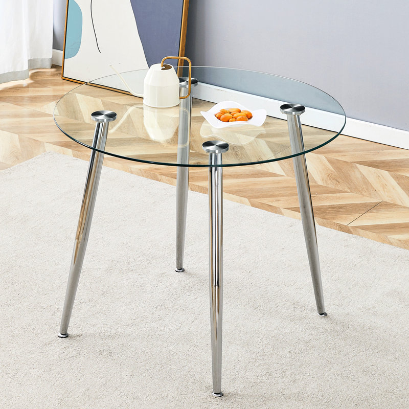 Table de salle à manger circulaire avec plateau en verre et pieds en métal
