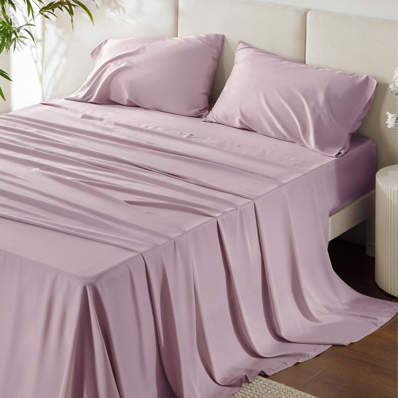 Lavender sheet set with a silky smooth finish on a made bed