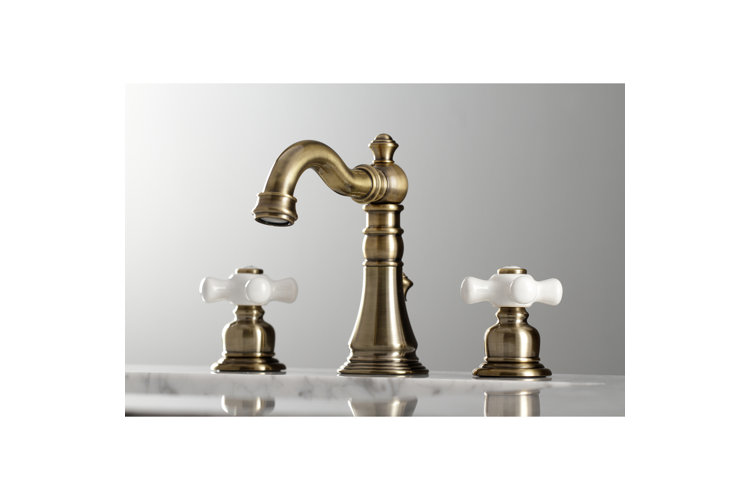 closeup shot of an antique brass finish bathroom sink faucet