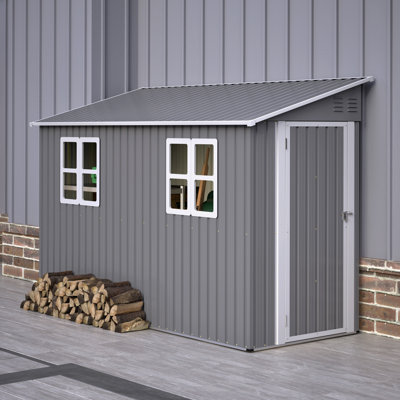 Abri de jardin adossé en métal 122 x 305 cm (4 x 10 pi) avec 2 fenêtres - 291 x 123 x 189 cm (114,5 x 48,6 x 74,2 po) - Métal - Monobloc - Gris - Avec plancher et porte réversible