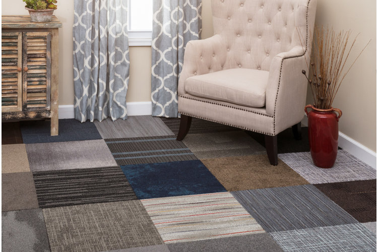 traditional living room with an upholstered chair and neutral carpet squares