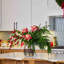 Royal Peppermint Noel - Real Touch Candy Cane Rose & Bud, Norfolk Branch & Red Snowberry in Large Smokey Wood Vase Water Illusion Arrangement