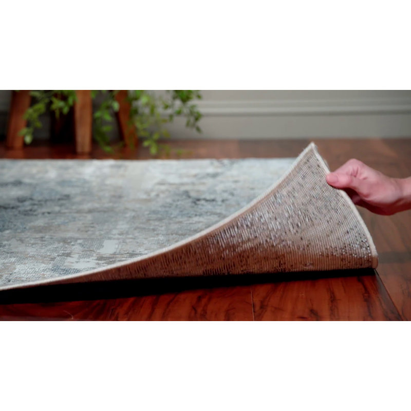 Ivory and Blue Abstract 8' x 10' Synthetic Area Rug