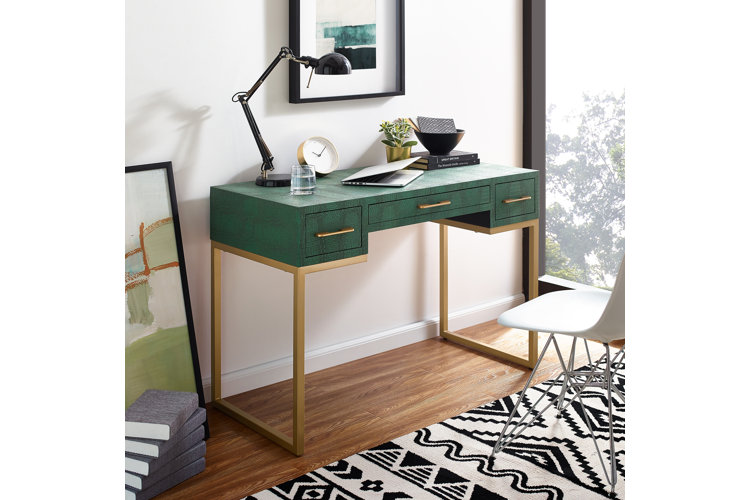 green desk with lamp and books