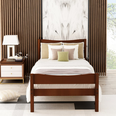 Lit plateforme simple en bois massif avec tête de lit, structure robuste en noyer