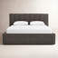Dark gray upholstered low-profile bed with a vertical channel-tufted headboard
