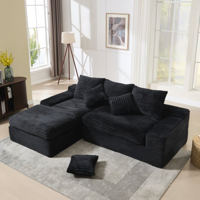 Canapé modulaire en L spacieux et modulaire en tissu noir pour le salon
