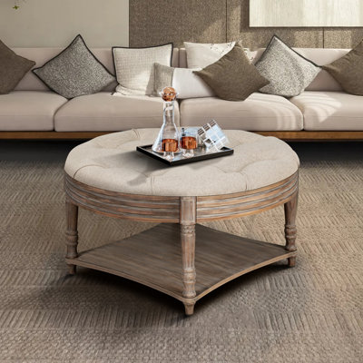 Grande table basse ronde capitonnée avec tablette de rangement en bois
