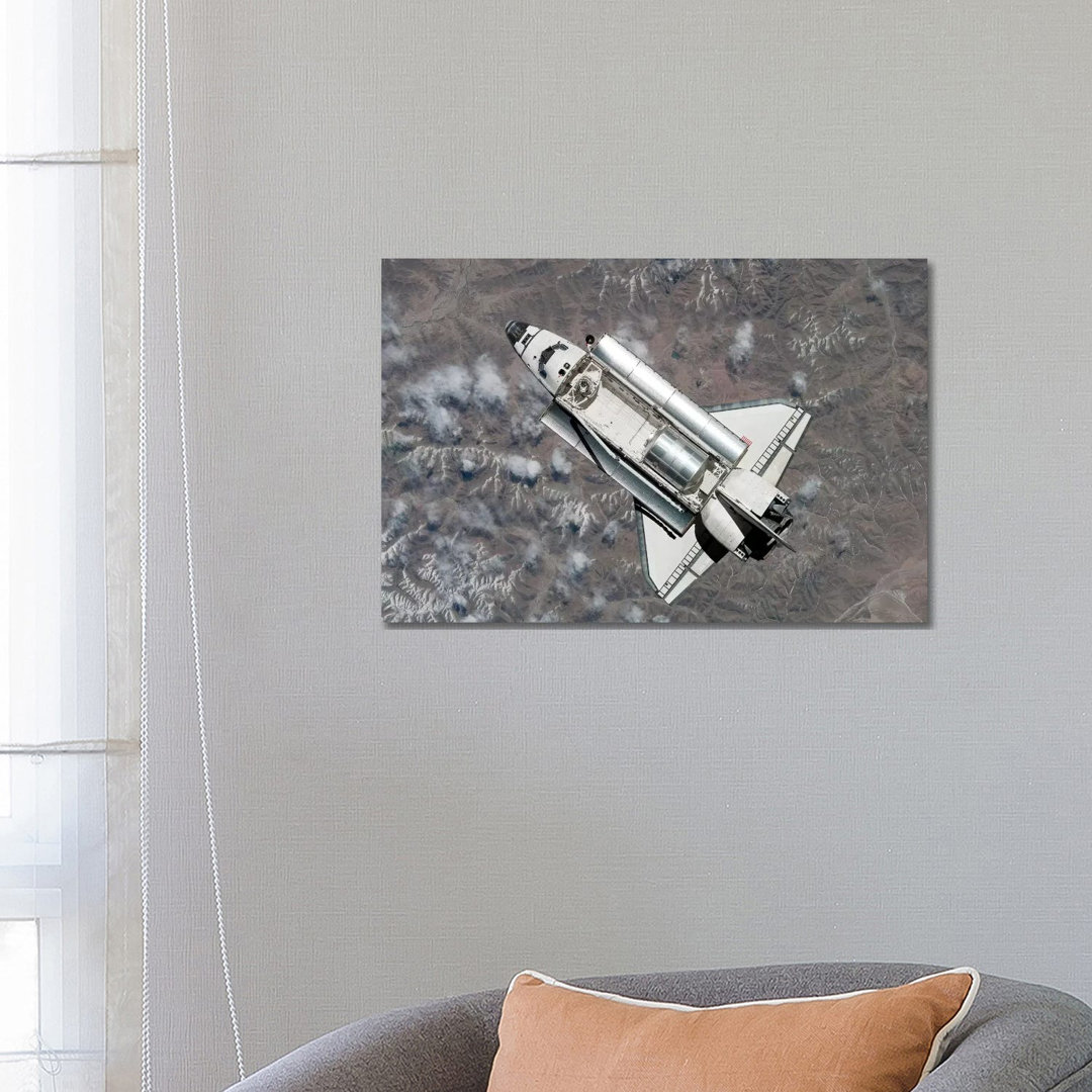 Aerial View Of Space Shuttle Discovery Over Earth As It Approaches The International Space Station by Stocktrek Images - Wrapped Canvas Print