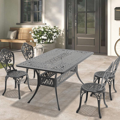 Mobilier de salle à manger en fonte d'aluminium résistant aux intempéries. Cadre noir, attrait intemporel. 100% de construction, aux éléments. Siège ergonomique. Patin en nylon Pa66. Assemblage facile requis. Sièges 4. Table rectangulaire avec
