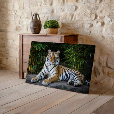 Canvas A Majestic Tiger Lounges Gracefully On A Rocky Surface Its Wall Art Powerful Body Partially Sprawled Out While Its Front Paws Canvas Wall Art