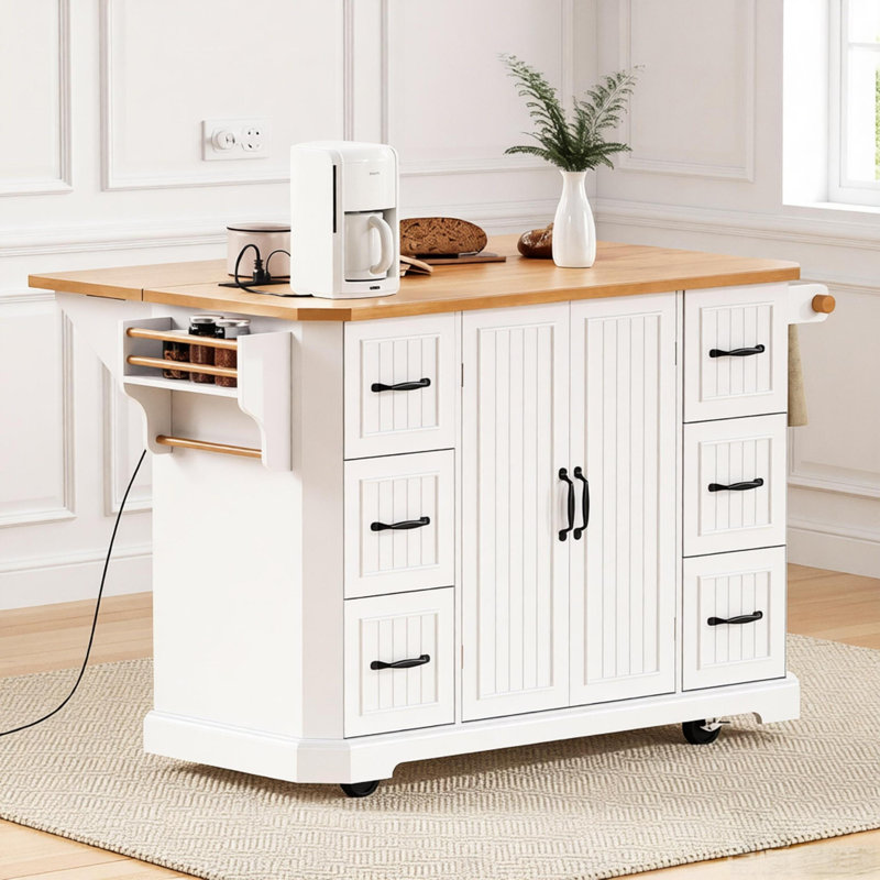 Îlot de cuisine avec abattant, prise de courant, 6 tiroirs profonds et 4 tablettes sur roulettes pour un rangement et un espace de travail flexibles.