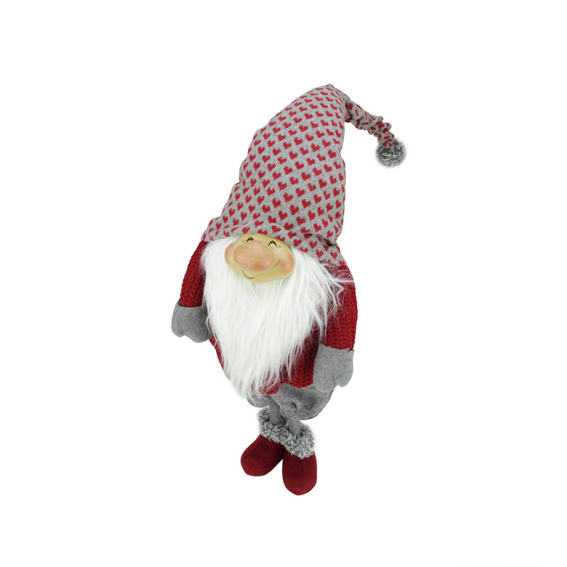 Rouge et gris «Randall» souriant avec un chapeau de père Noël debout sur une table de Noël gnome