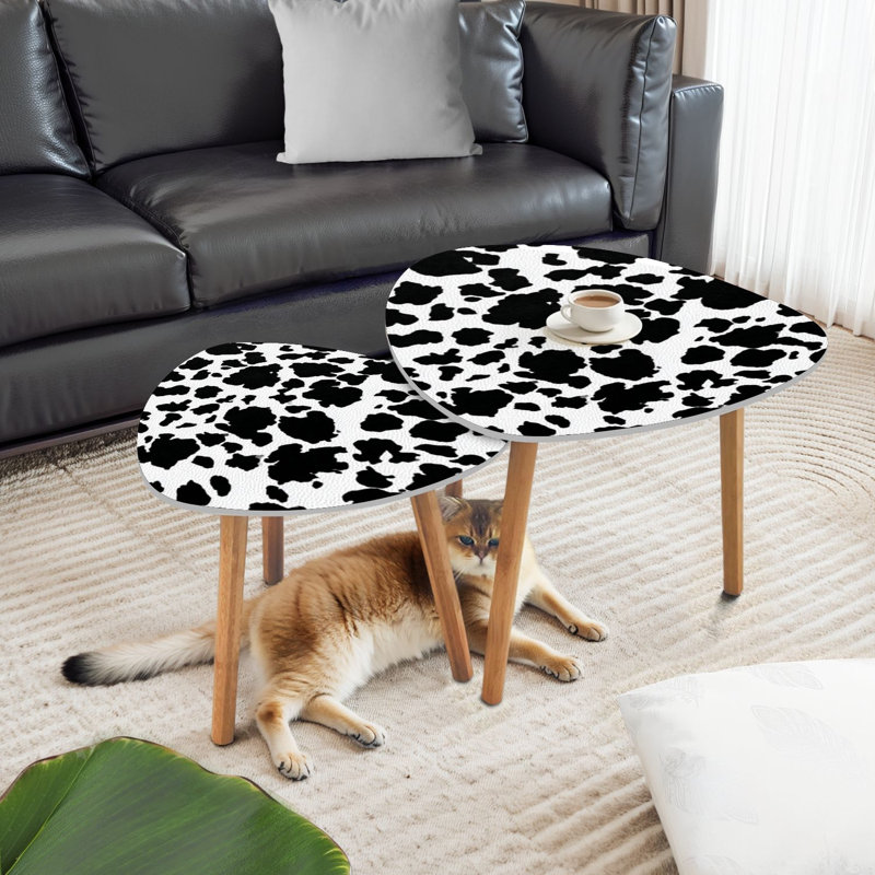 Ensemble de 2 tables gigognes triangulaires en peau de vache noir et blanc