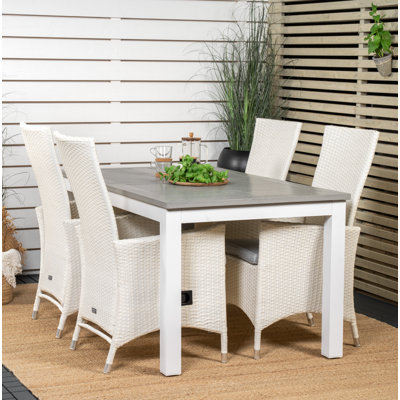 Jayesh 4 - Person Patio Dining Set with Extendable Rectangular Table , Cushions Included