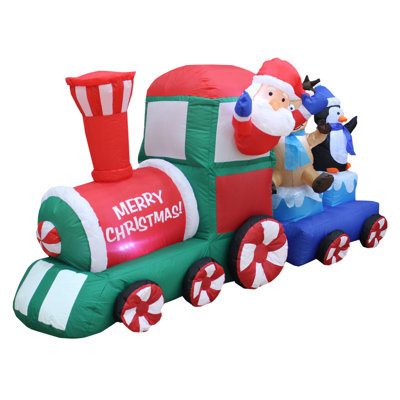 Père Noël dans un train gonflable de Noël