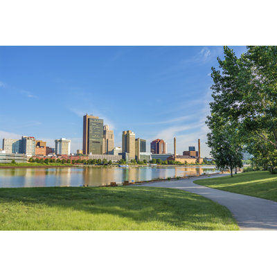A City Skyline Reflected In A Smooth Lake Surface by Mshake - Wrapped Canvas Print