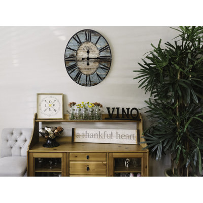 Horloge murale décorative de forme ovale en bois à finition patinée Rachual