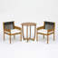 Ensemble bistro de patio Celia pour 2 personnes, style côtier moderne, en bois d'acacia, avec fauteuils à accoudoirs tressés, coussins et table ronde à lattes.