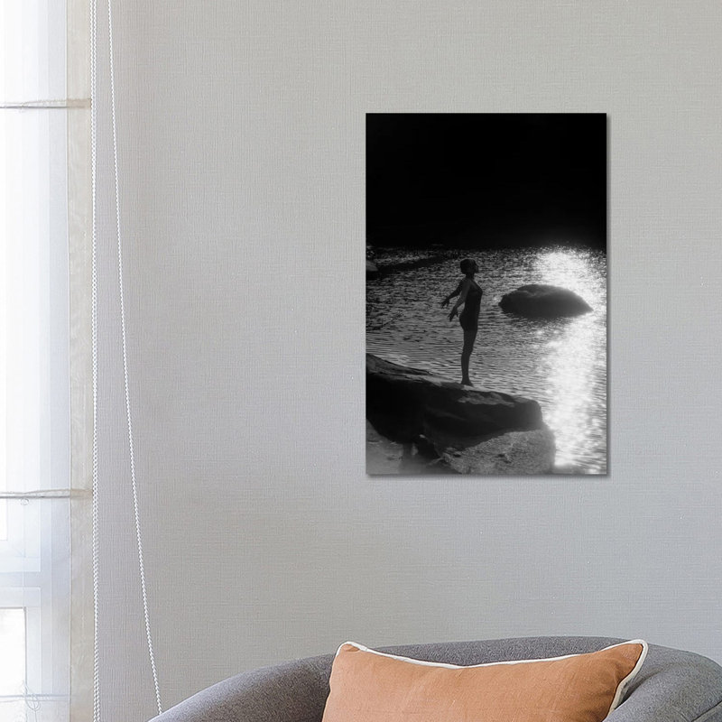 1920s Sunset Silhouette Of Anonymous Woman Standing On A Rock Near Water About To Dive In by Vintage Images - Wrapped Canvas Print