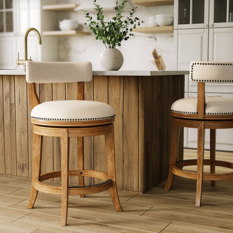Tabouret de comptoir pivotant rembourré avec structure en bois massif Carollynn