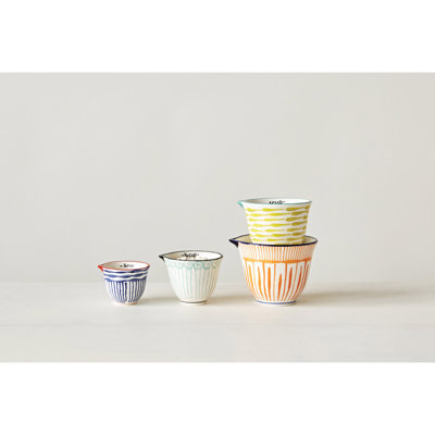 4‑Piece Hand‑Painted Stoneware Measuring Cups with Patterns