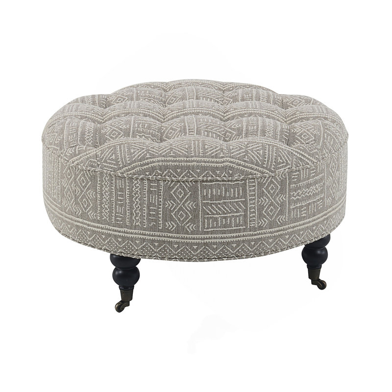 Repose-pieds Upendo avec roulettes, tissu à motifs pour une utilisation polyvalente et une mobilité accrue, parfait pour tout décor de pièce.
