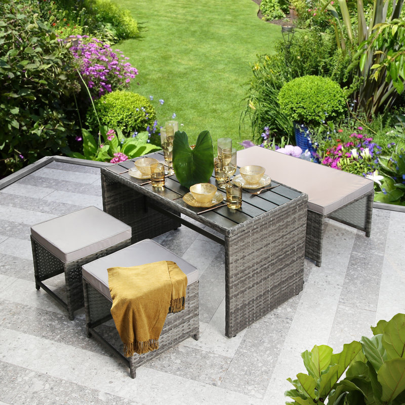 Kiwon 4 - Person Wicker Patio Dining Set with Rectangular Table , Cushions Included