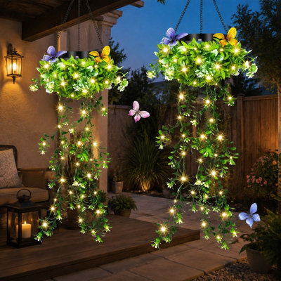 A 2 Pack of solar hanging garden lanterns integrates 66 LED lights with realistic grass & White Flowers, IP65 waterproof protection, and Auto On/Off operation for patios, porches, fences, pergolas, or backyards. For outdoor use.