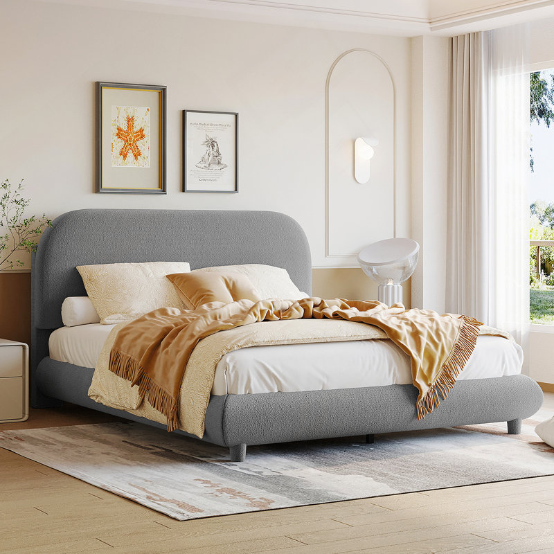 Lit plateforme tapissier avec tissu épais, structure solide et design élégant en forme de courbe