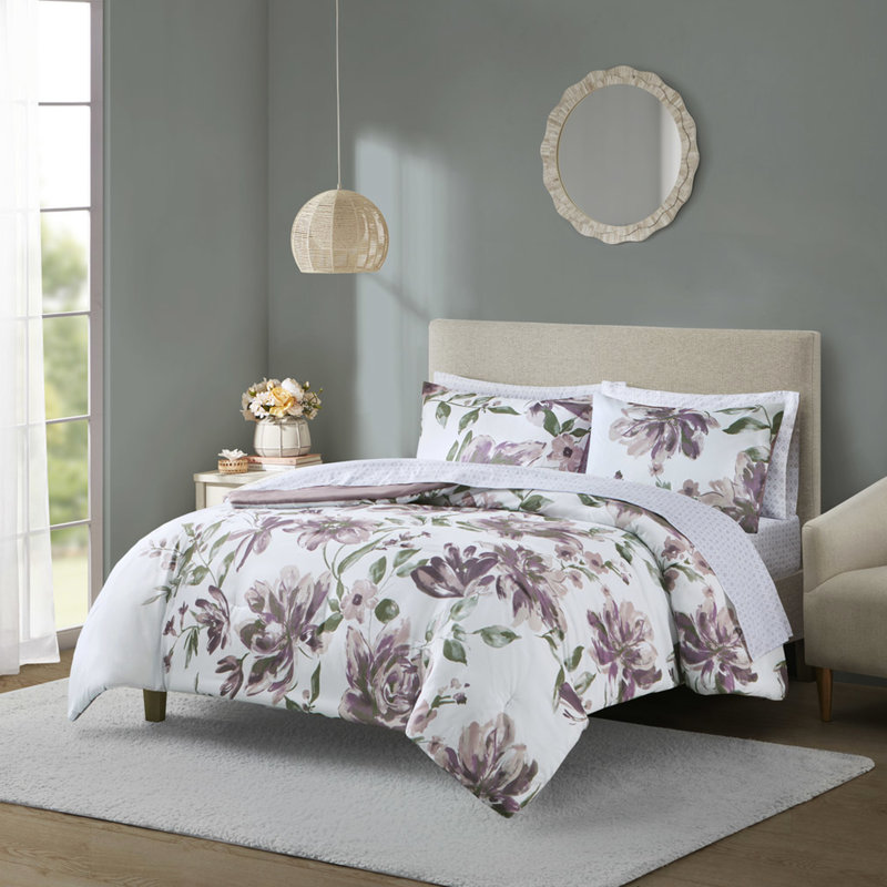 Édredon et drap mauve à motif floral pour une chambre douillette avec taupe