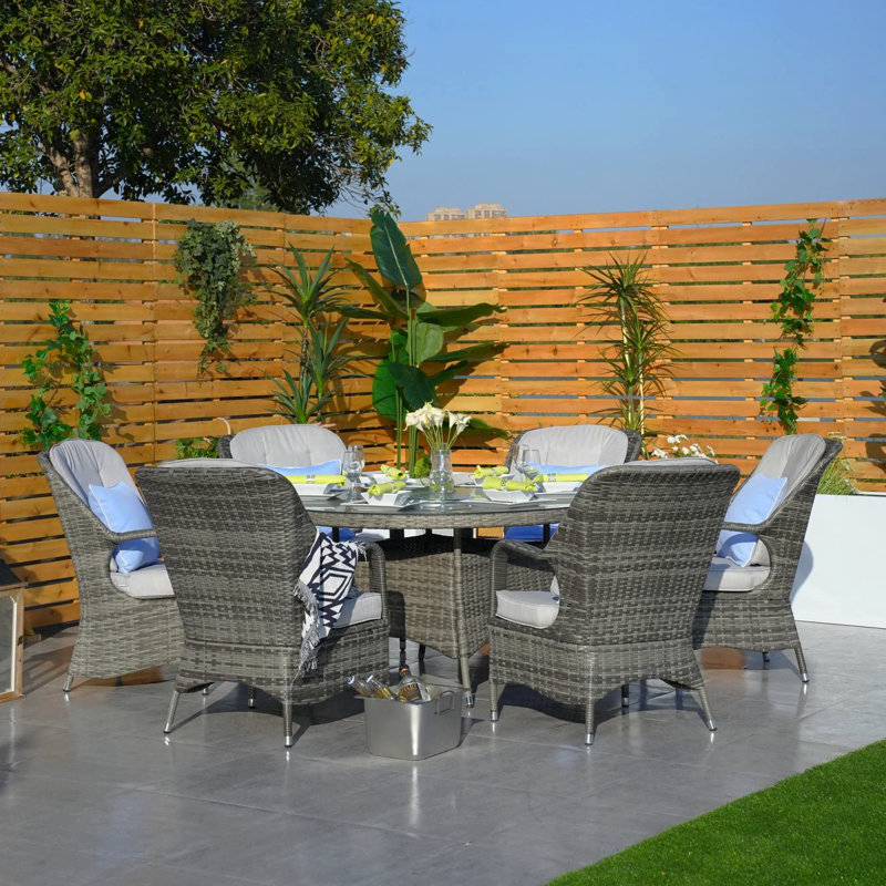 Algird 6 - Person Wicker Patio Dining Set with Round Table , Cushions Included, Gray