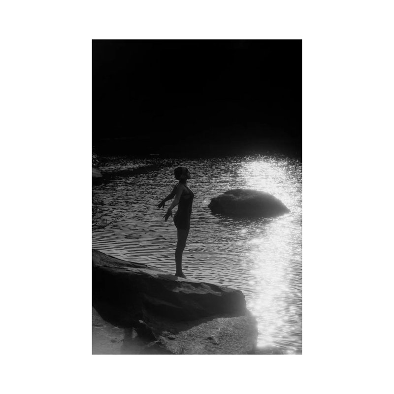 1920s Sunset Silhouette Of Anonymous Woman Standing On A Rock Near Water About To Dive In by Vintage Images - Wrapped Canvas Print