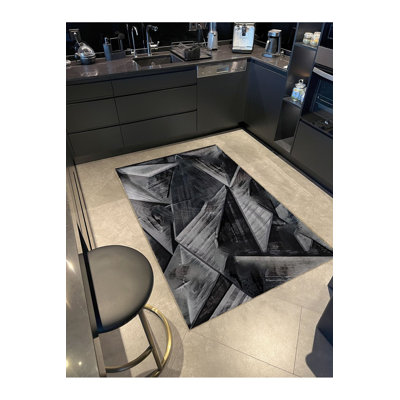 Tapis décoratif noir à motif géométrique vibrant à motif abstrait noir