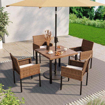 Aljaquan 4 - Person Wicker Patio Dining Set with Rectangular Table , Cushions Included by Latitude Run