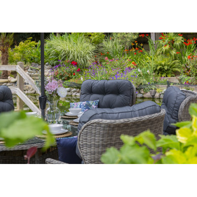 Raeburn 6 - Person Patio Dining Set with Round Table , Cushions Included