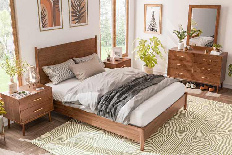 bedroom with wood bed frame, matching nightstand and dresser, styled with warm medium wood tones and neutral bedding