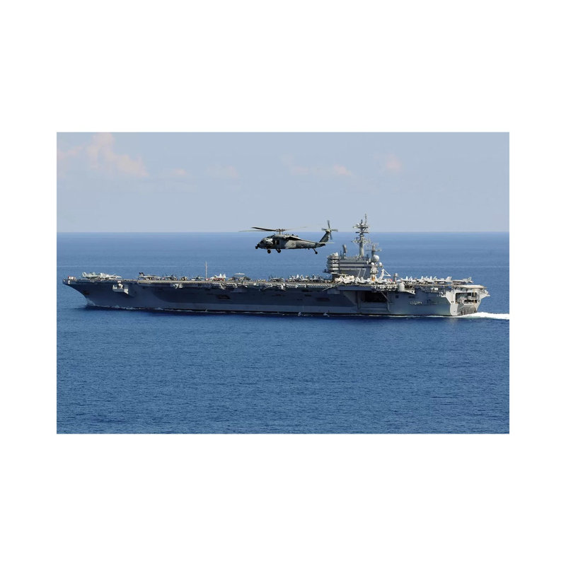 An MH-60S Seahawk Helicopter Flies Over USS George H.W. Bush by Stocktrek Images - Wrapped Canvas Print