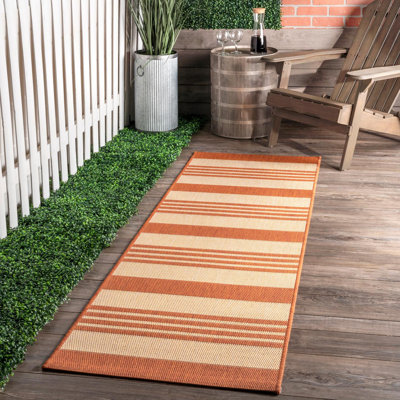 Tapis rayé intérieur / extérieur pour terrasse de salon Haydon, terre cuite / ivoire