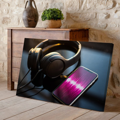 Canvas A Sleek Pair Of Black Over Ear Headphones Rests On Wall Art A Glossy Black Surface Reflecting Subtle Highlights And Shadows The Canvas Wall Art
