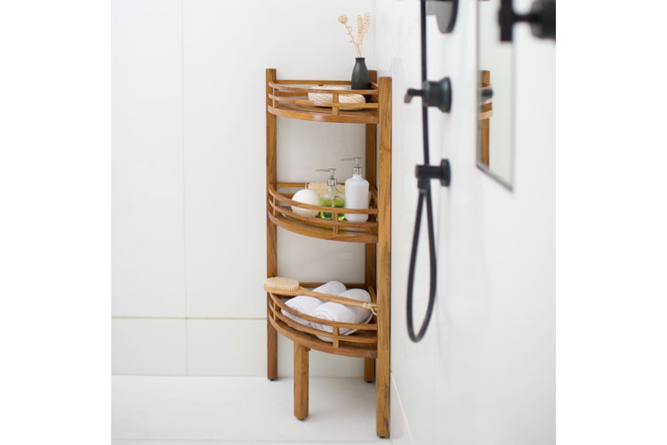 shower storage idea with a three-tiered wooden corner shelf in the a white shower enclosure.