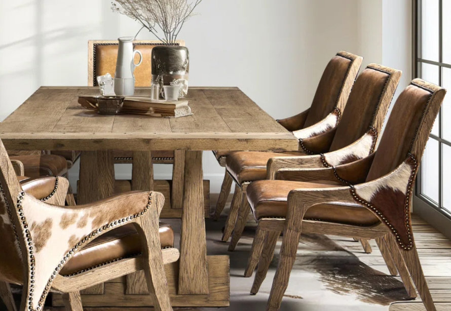 Dining room with a wooden table and leather chairs.