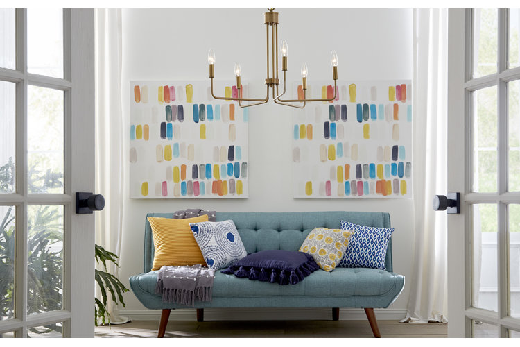 two abstract paintings over an entryway bench