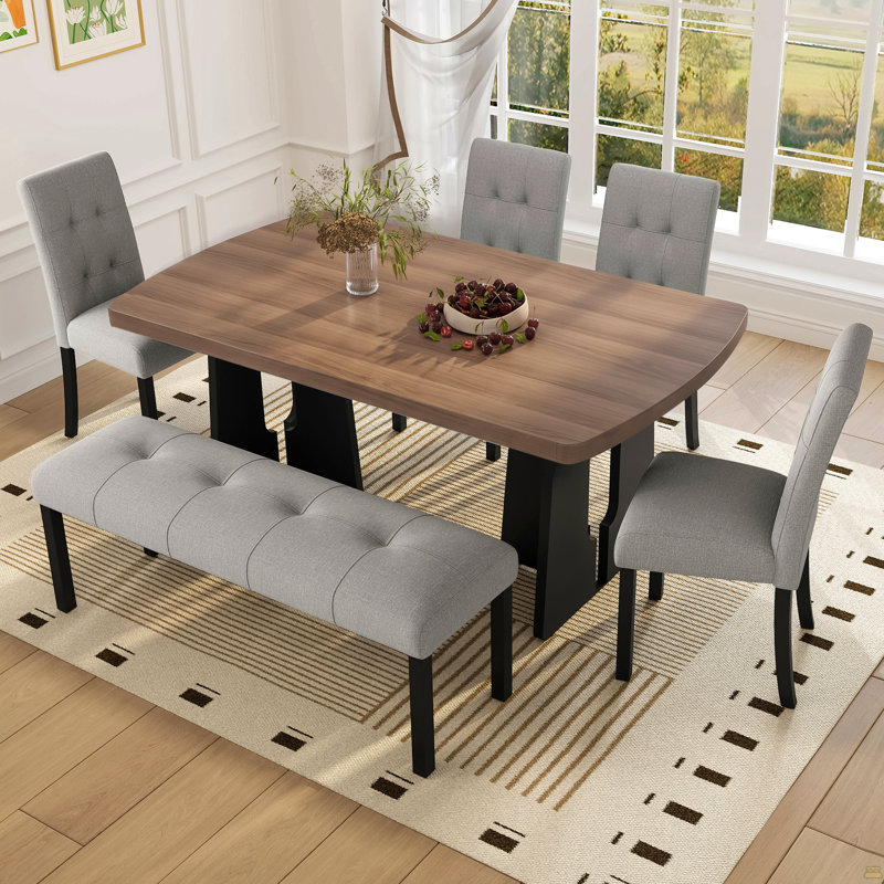 Ensemble de salle à manger moderne de 6 pièces : table de 160 cm avec pattes géométriques, 4 chaises rembourrées et 1 banc. Convient à la cuisine ou à la salle à manger. Montage facile. Table en noyer et noir avec assises grises.