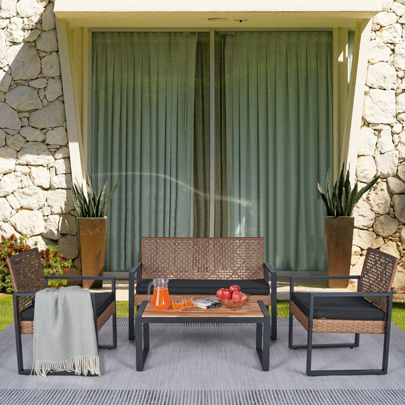 Anetta 4 - Person Wicker Patio Dining Set with Rectangular Table , Cushions Included, Brown/Black, Black