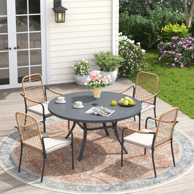 4-Person Patio Dining Set with Round Dining Table and Cushioned Rattan Stackable Chairs